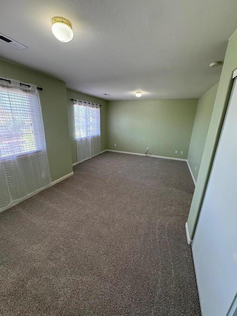 949 Terraza Street Soledad, CA 93960 - Photo 21 of 38 an empty room with windows