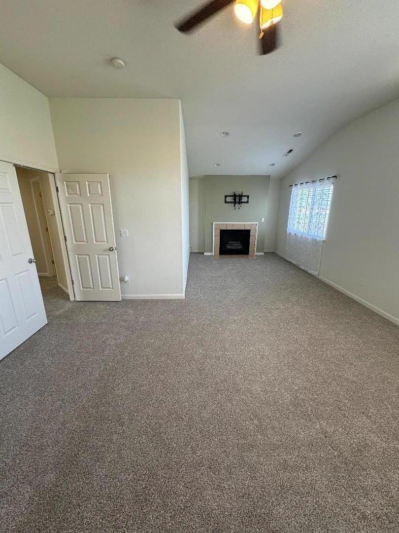 949 Terraza Street Soledad, CA 93960 - Photo 22 of 38 an empty room with windows and fireplace