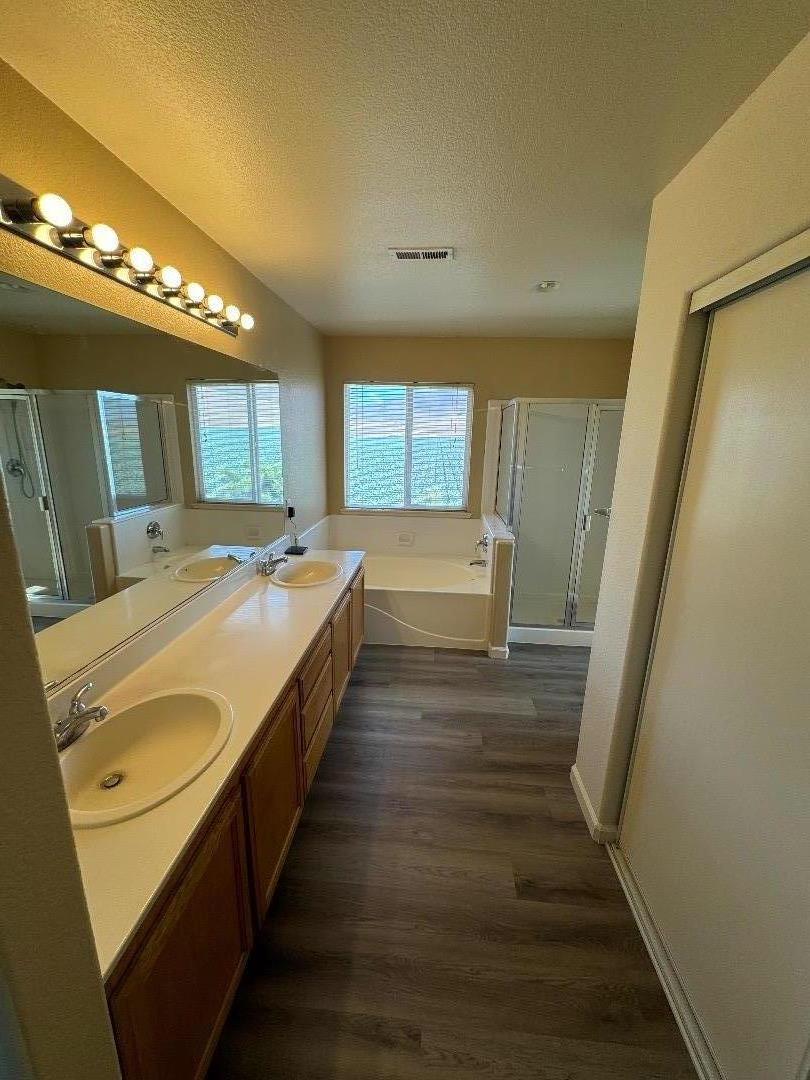 949 Terraza Street Soledad, CA 93960 - Photo 24 of 38 a spacious bathroom with a double vanity sink and a mirror