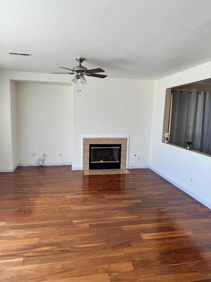 949 Terraza Street Soledad, CA 93960 - Photo 6 of 38 a view of empty room with wooden floor and fireplace