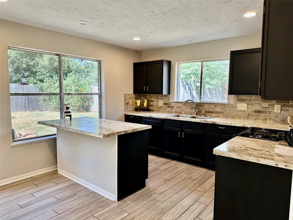 a kitchen with a sink and wooden cabinets