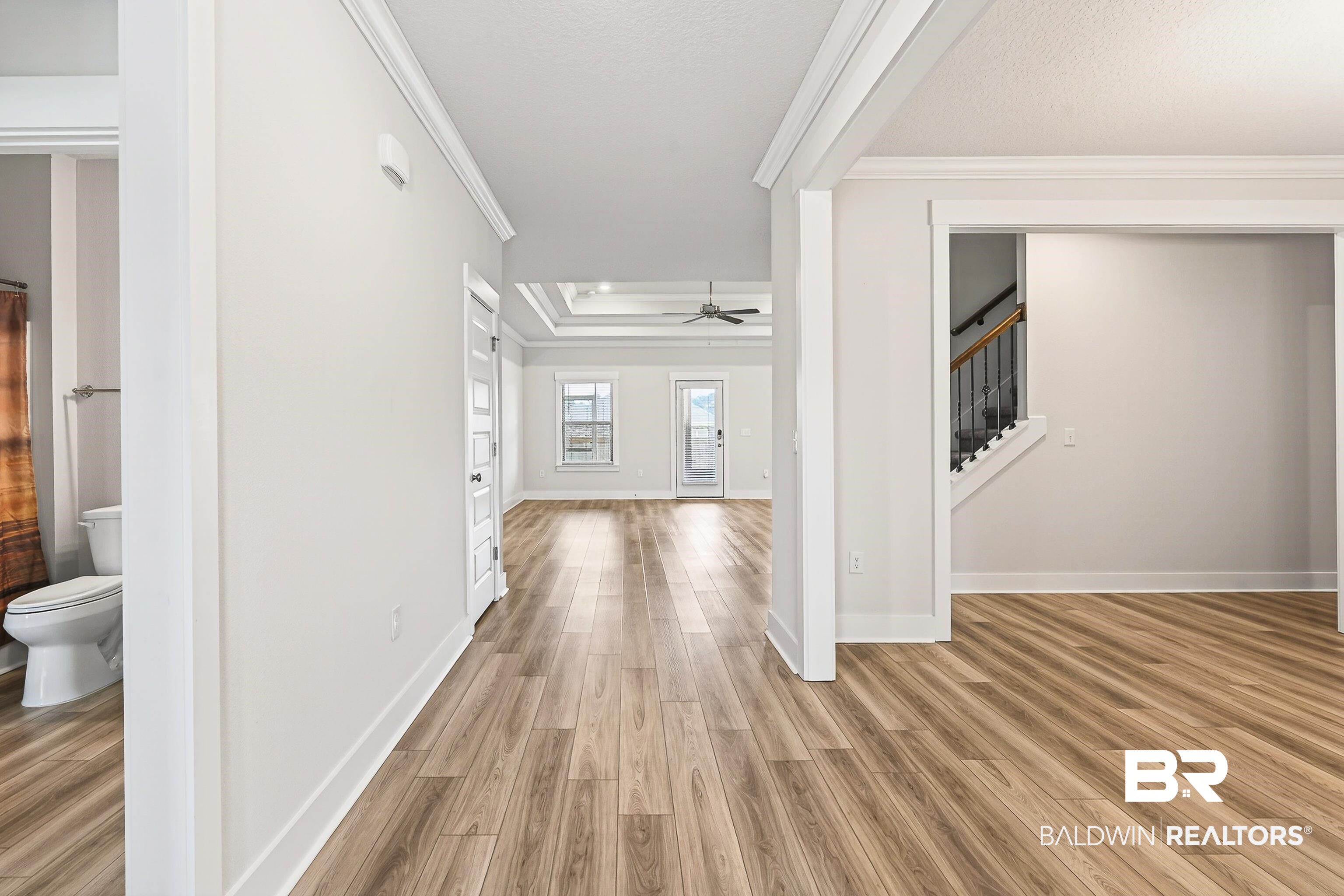 1728 Partridge Street Foley, AL 36535 - Photo 6 of 37 Corridor with light wood-style floors, ornamental molding, and a tray ceiling