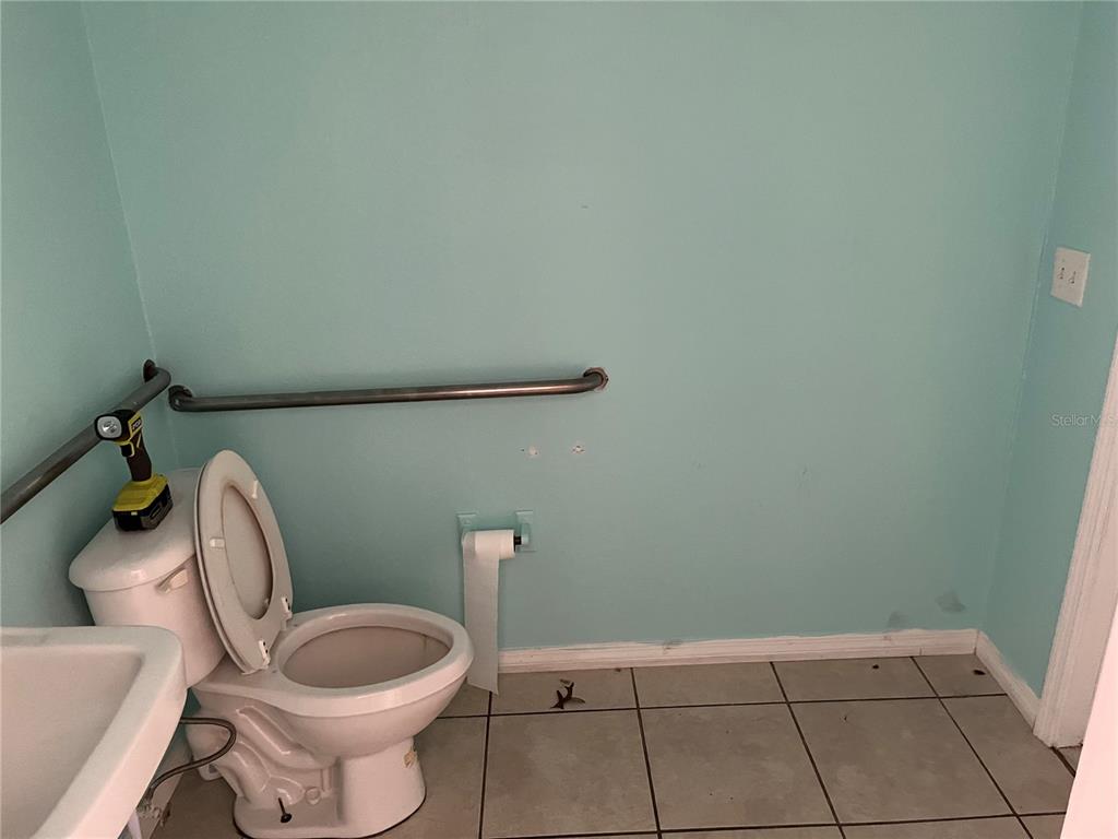 18132 Commercial Way Weeki Wachee, FL 34614 - Photo 16 of 22 a bathroom with a toilet and a sink