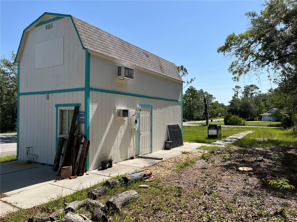 18132 Commercial Way Weeki Wachee, FL 34614 - Photo 2 of 22 a view of a house with backyard