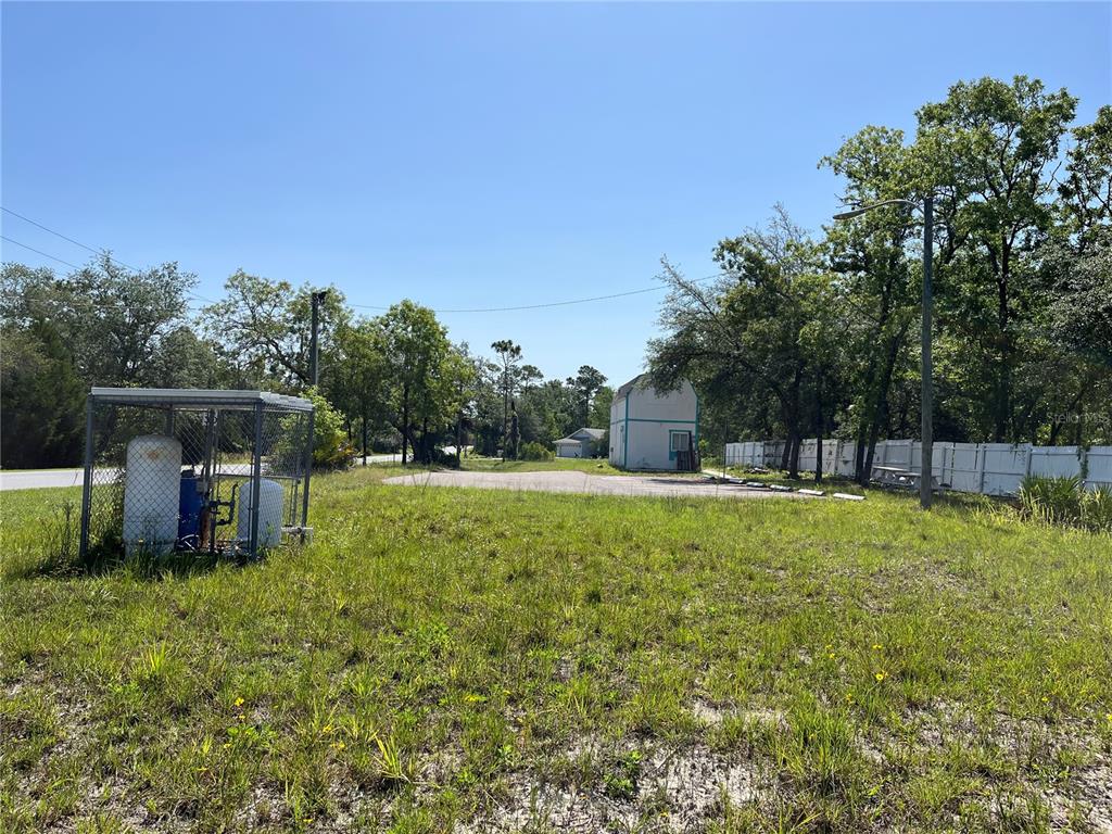 18132 Commercial Way Weeki Wachee, FL 34614 - Photo 21 of 22 a view of a house with a yard