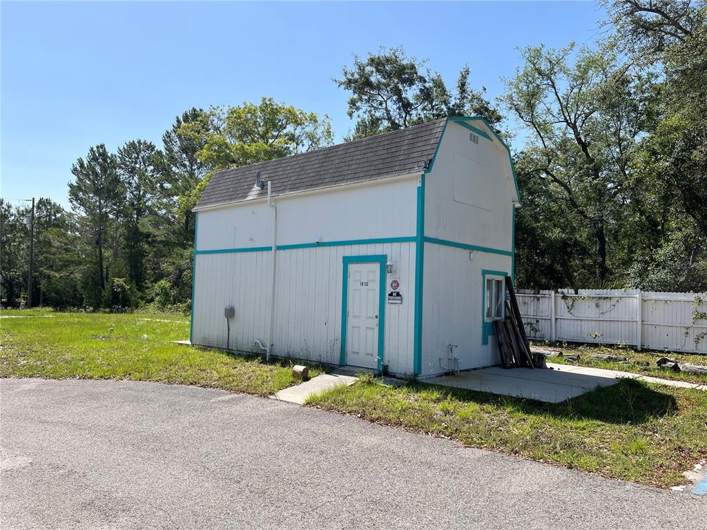 18132 Commercial Way Weeki Wachee, FL 34614 - Photo 3 of 22 a view of a back yard of the house