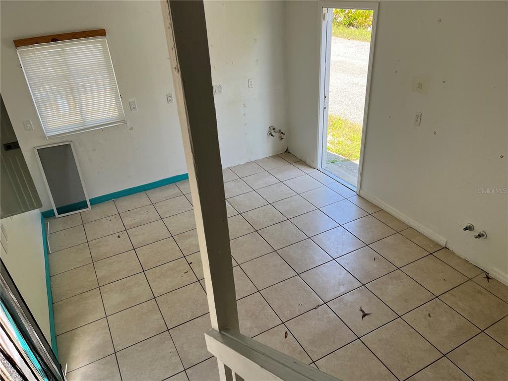 18132 Commercial Way Weeki Wachee, FL 34614 - Photo 8 of 22 a view of an empty room and wooden floor