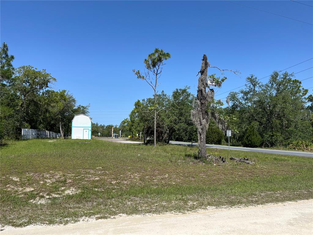 18132 Commercial Way Weeki Wachee, FL 34614 - Photo 9 of 22 a view of a green field
