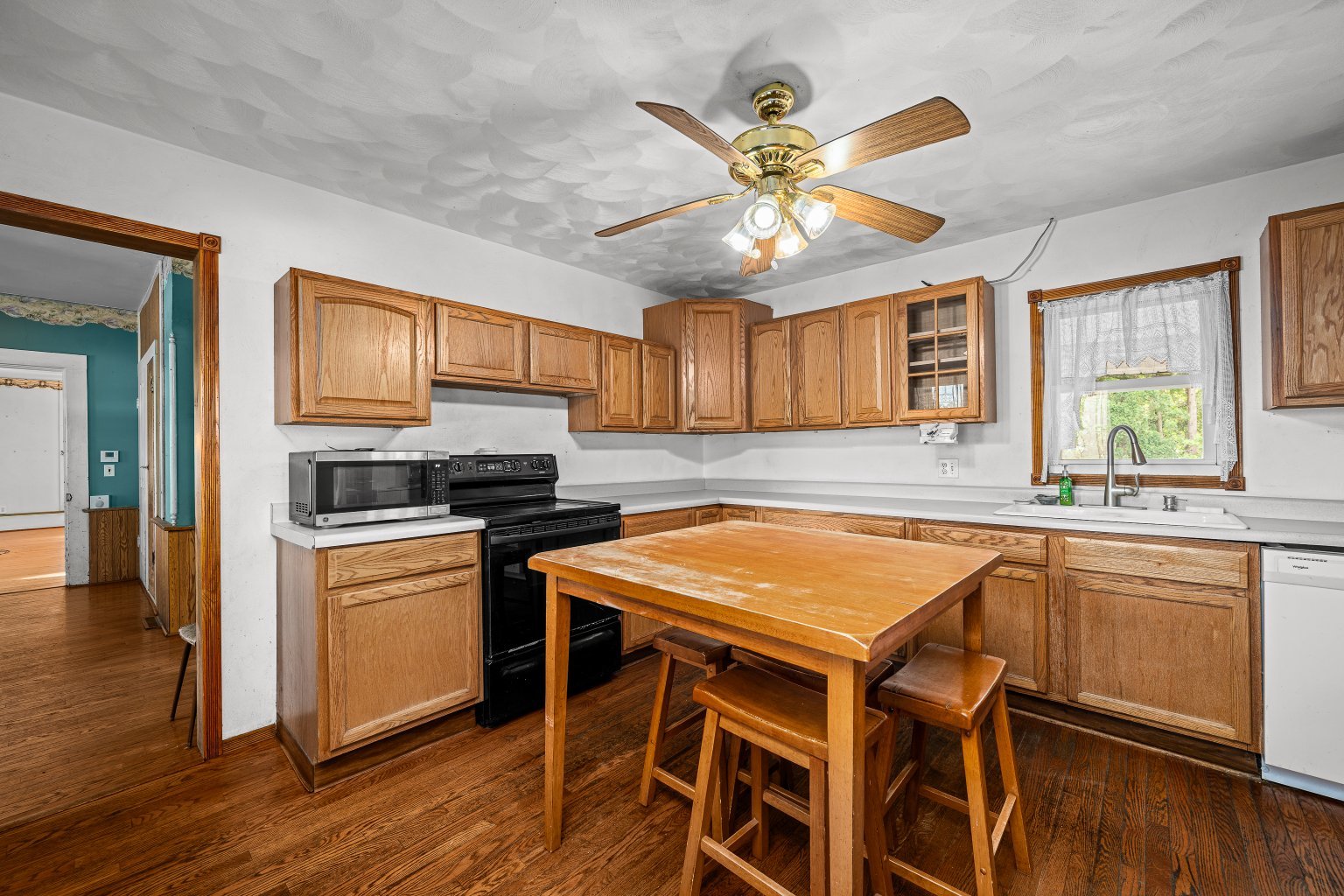 200 West Locust Street Cambridge, IL 61238 - Photo 13 of 32 a kitchen with stainless steel appliances granite countertop hardwood floor sink stove and wooden cabinets