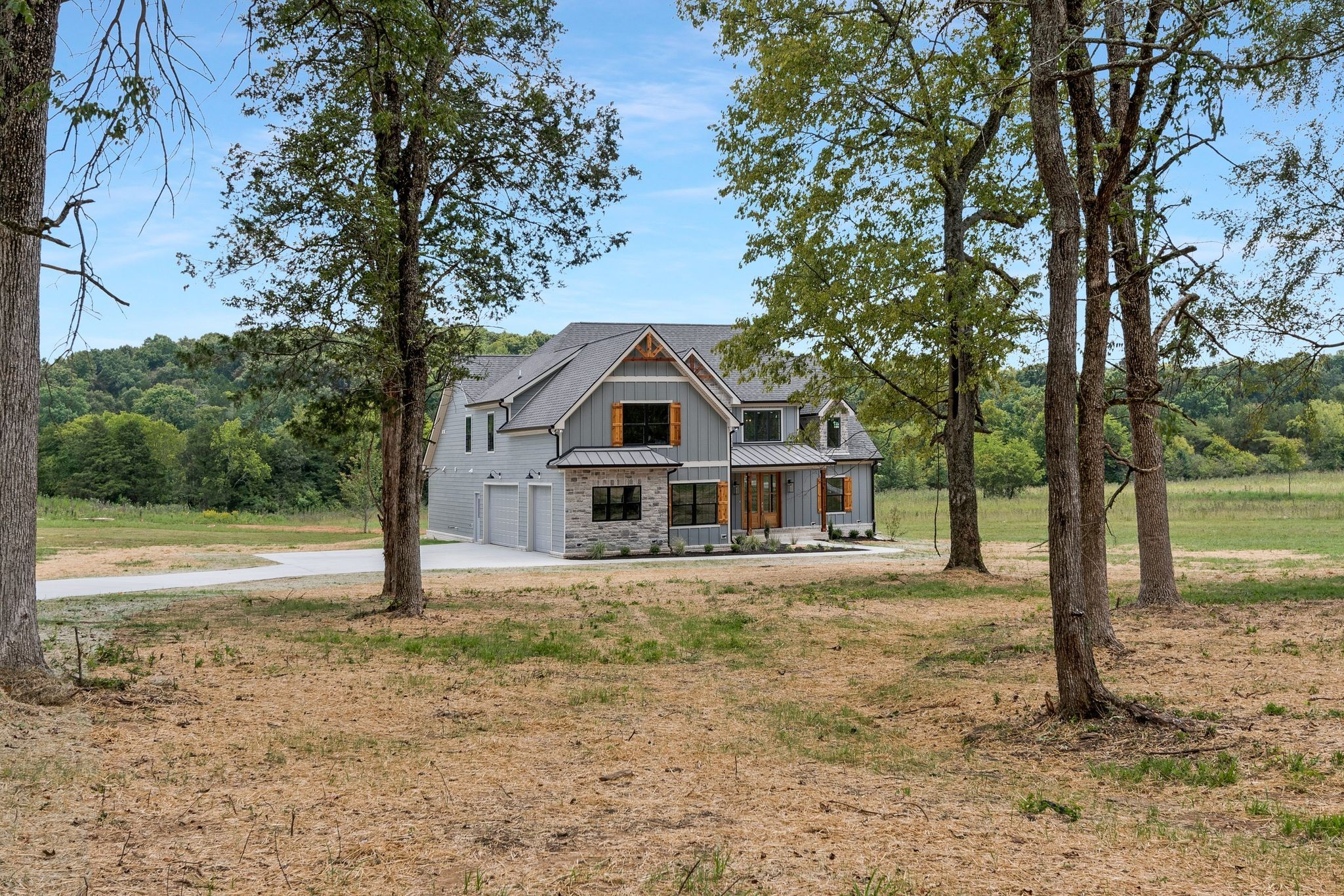 4114 Chicken Road Lebanon, TN 37090 - Photo 6 of 52 a house with trees in the background