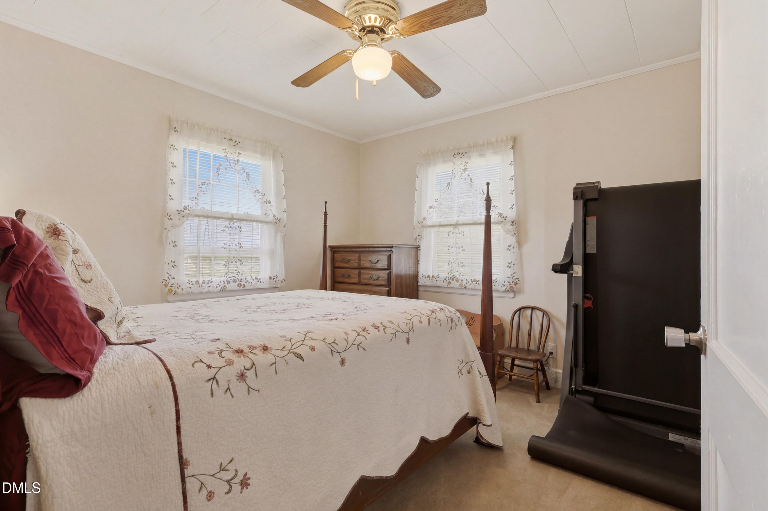 2631 South Jim Minor Road Haw River, NC 27258 - Photo 30 of 62 a bedroom with a bed a window and a chandelier