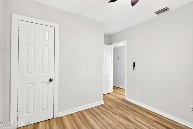 a view of a room with wooden floor