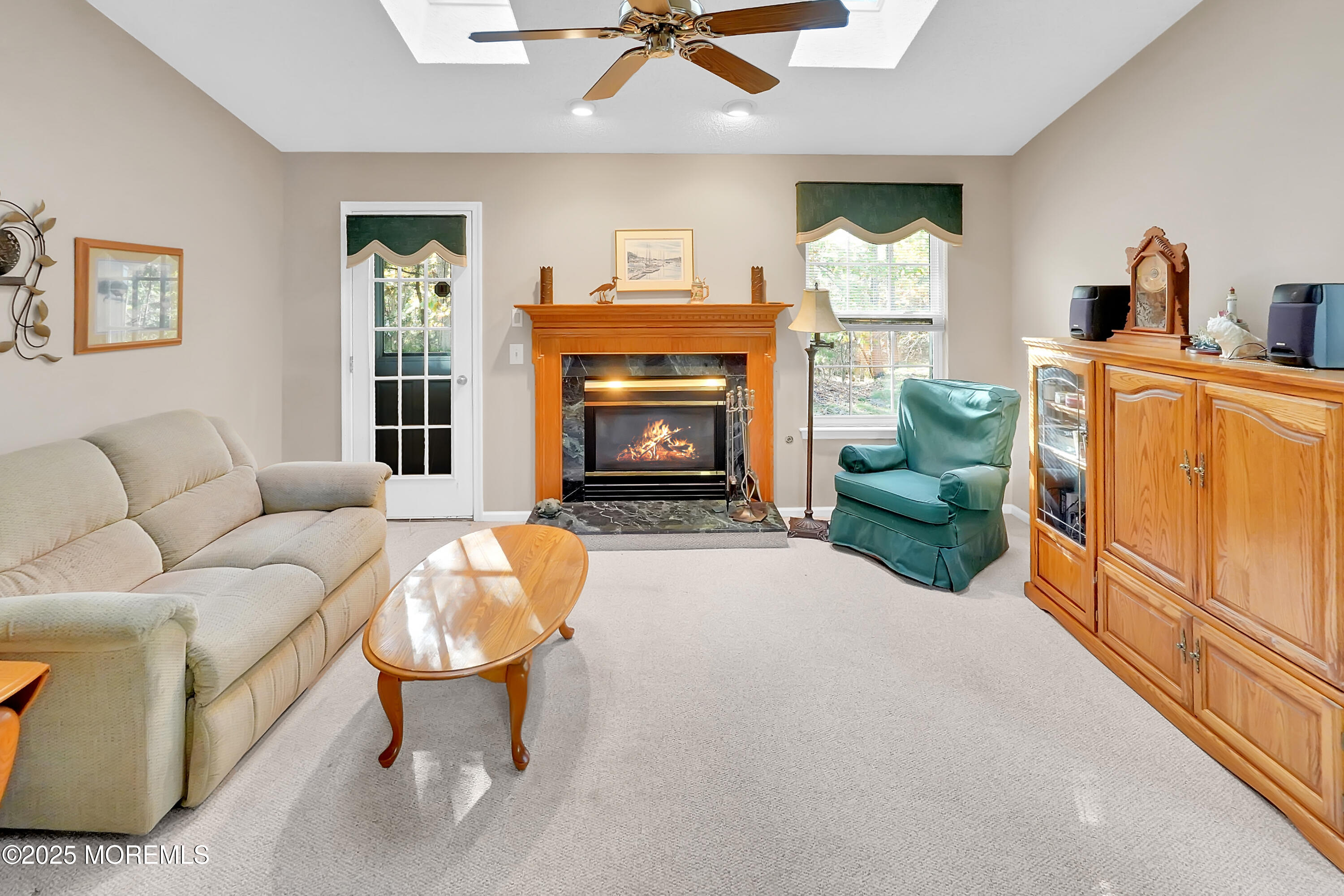 9 Abbot Court Jackson, NJ 08527 - Photo 21 of 47 a living room with furniture a fireplace and a flat screen tv