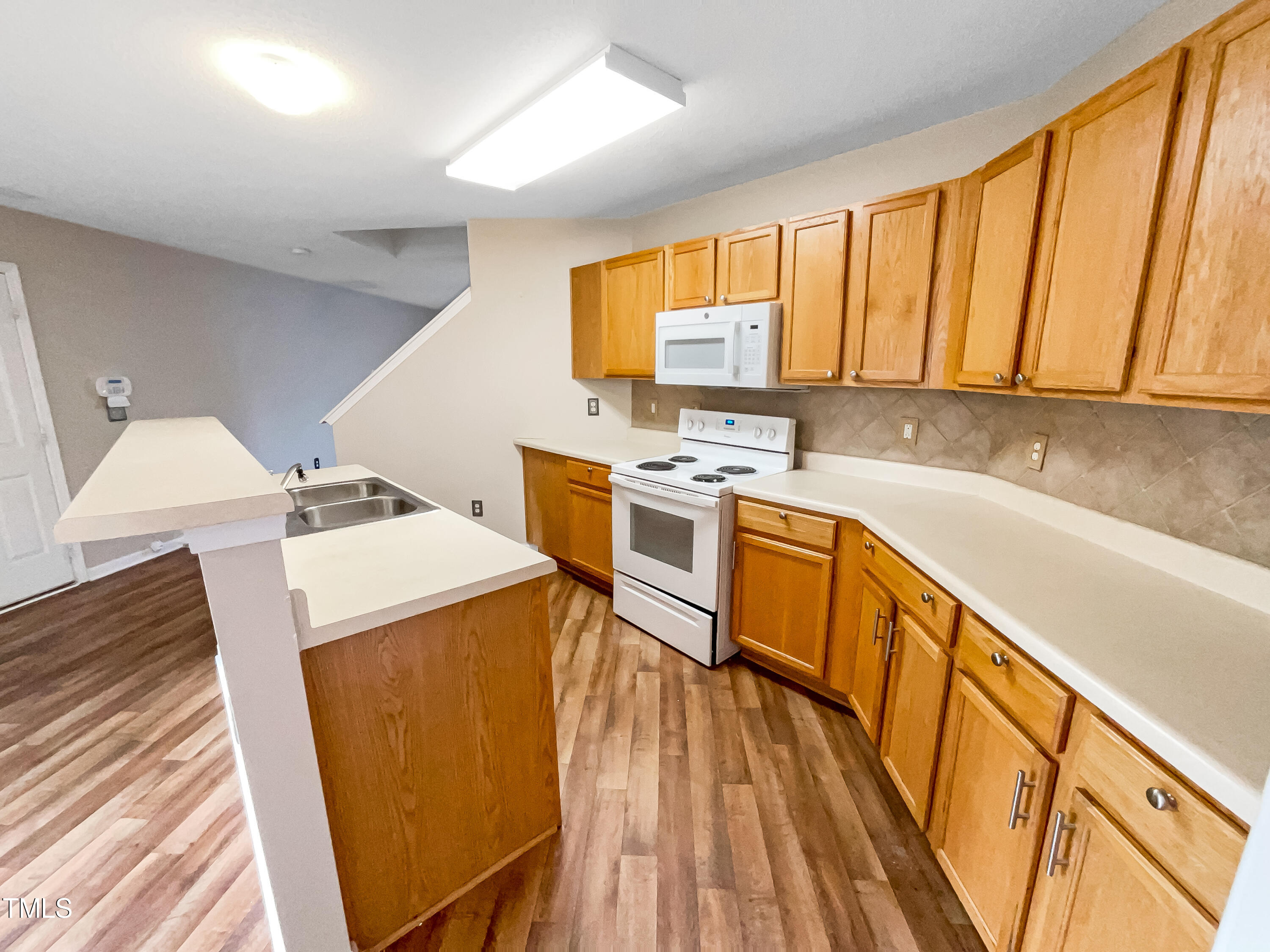 3729 Tryon Ridge Drive Raleigh, NC 27610 - Photo 8 of 21 a view of a kitchen with wooden floor and electronic appliances