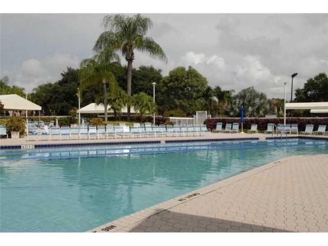 5265 Brisata Circle, Unit E Boynton Beach, FL 33437 - Photo 16 of 20 a view of a swimming pool with chairs