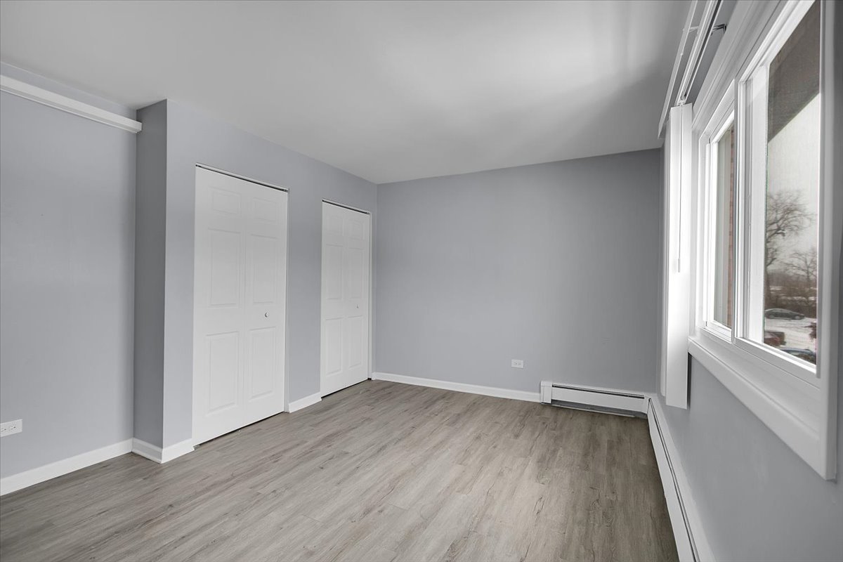 10310 Ridgeland Avenue, Unit 208 Chicago Ridge, IL 60415 - Photo 18 of 29 a view of a room with wooden floor and window