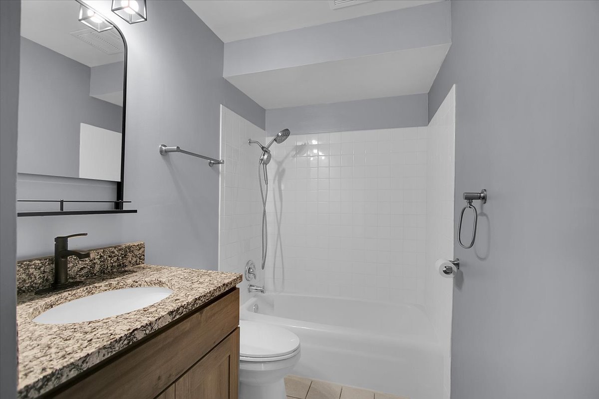 10310 Ridgeland Avenue, Unit 208 Chicago Ridge, IL 60415 - Photo 22 of 29 a bathroom with a granite countertop sink toilet and shower