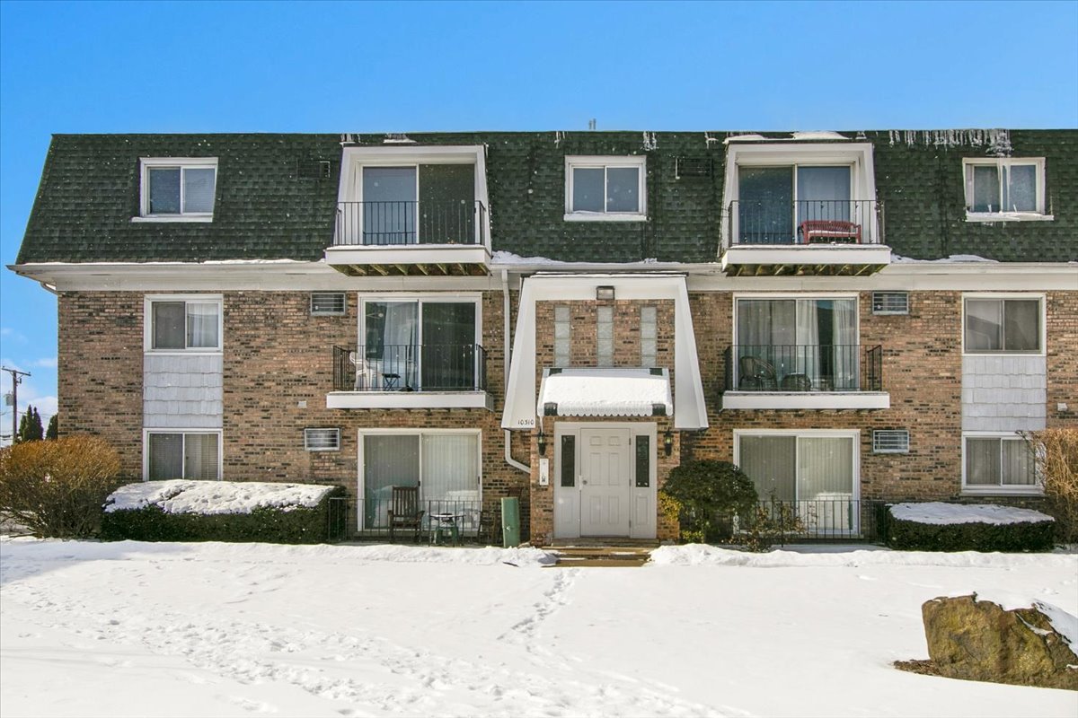 10310 Ridgeland Avenue, Unit 208 Chicago Ridge, IL 60415 - Photo 4 of 29 a front view of a house with a yard and garage