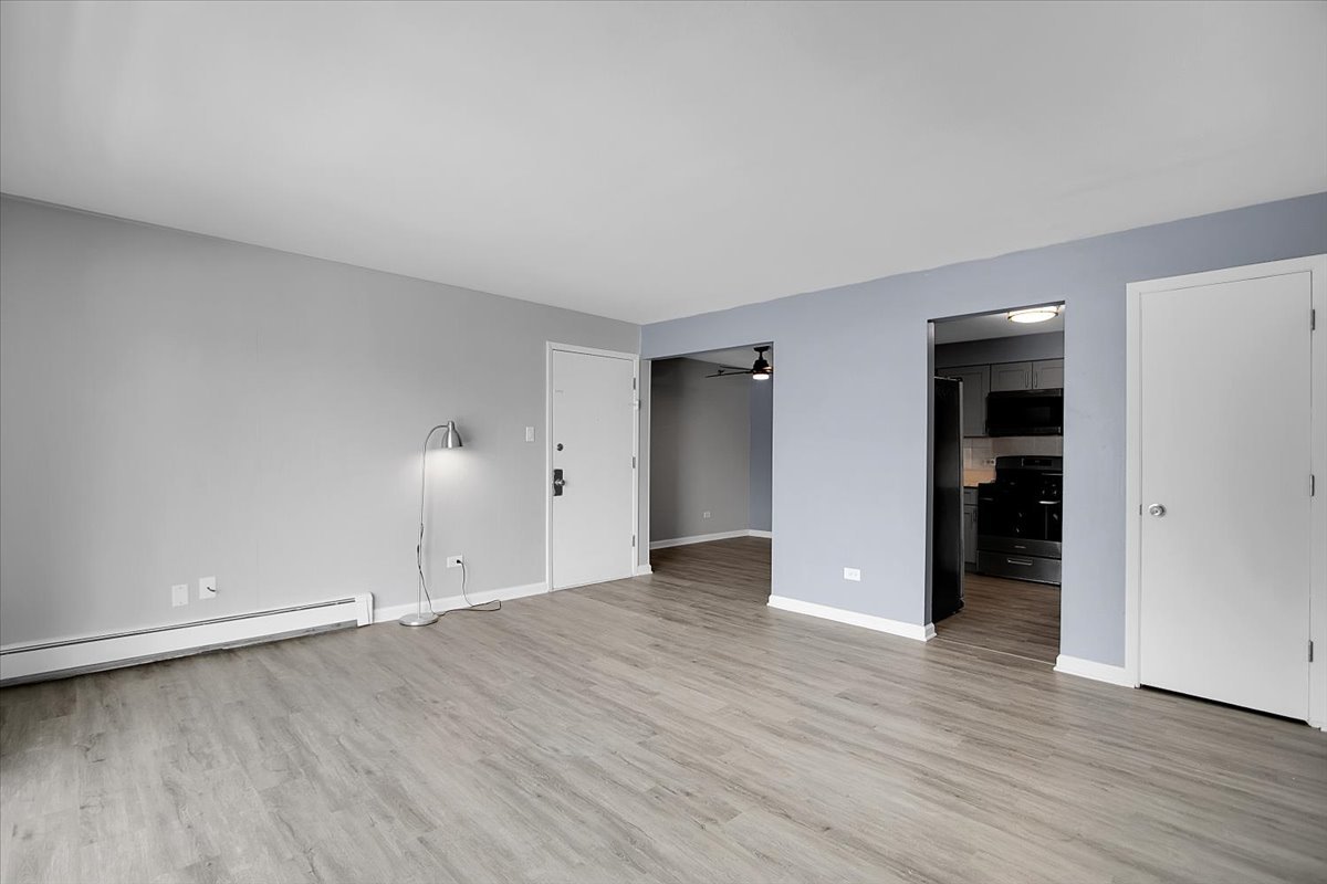 10310 Ridgeland Avenue, Unit 208 Chicago Ridge, IL 60415 - Photo 9 of 29 an empty room with wooden floor and closet