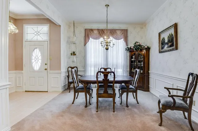 a view of a dining room with furniture and chandelier