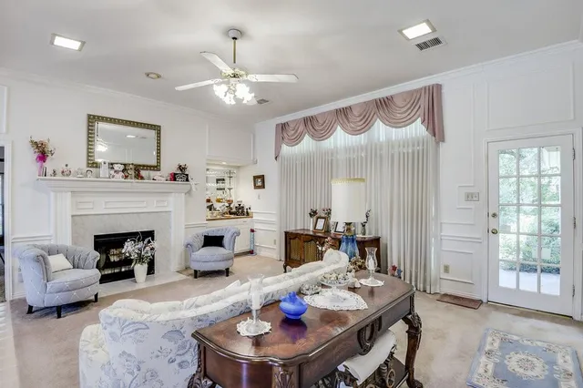 a living room with furniture a fireplace and a table