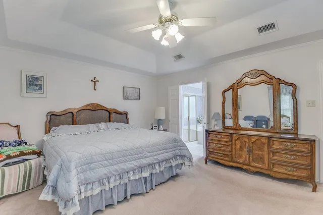 a bedroom with a bed a dresser and mirror