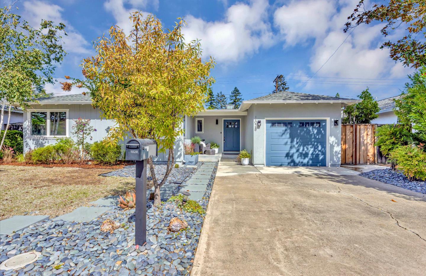 a front view of a house with garden and patio