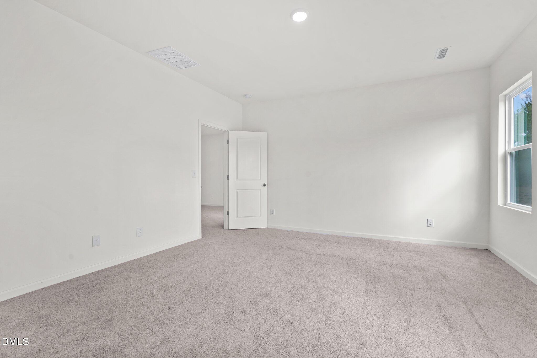 167 Bedstone Way Clayton, NC 27520 - Photo 23 of 24 a view of an empty room with a window
