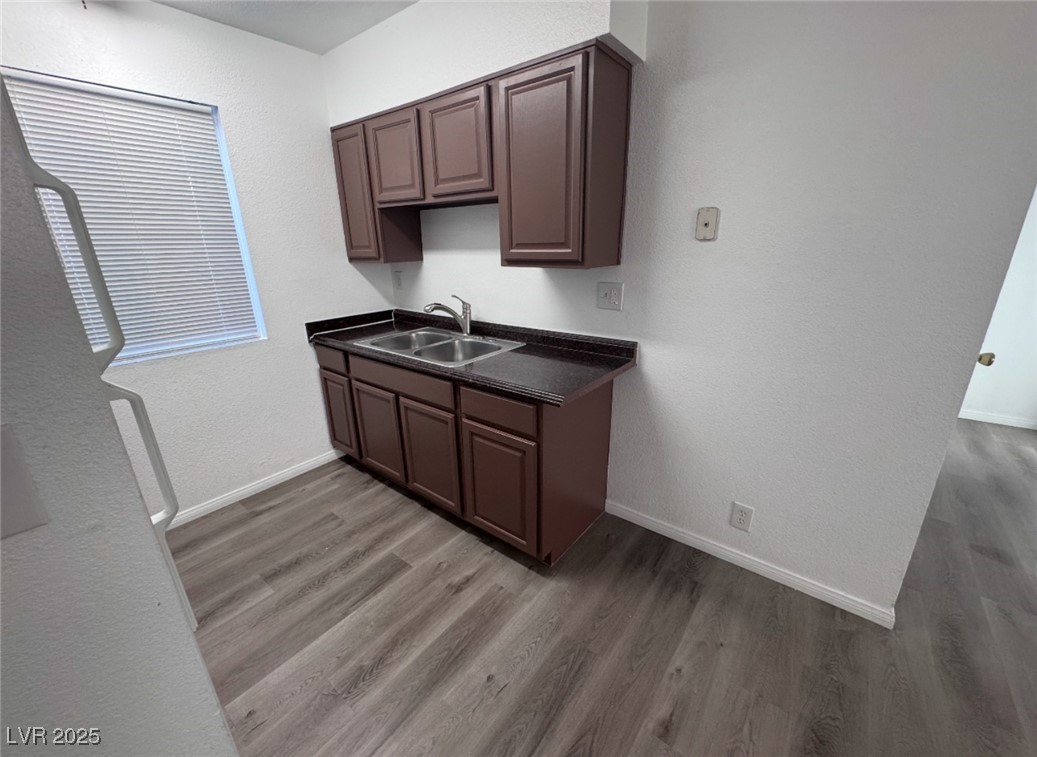 Undisclosed Address Henderson, NV 89011 - Photo 3 of 8 Kitchen featuring wood finished floors, a sink, ba