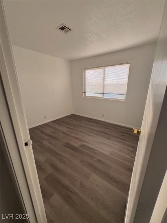 Undisclosed Address Henderson, NV 89011 - Photo 7 of 8 Empty room featuring dark wood-type flooring, visi