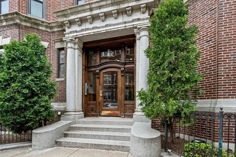a front view of a house with plants