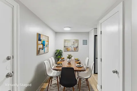 a dining room with furniture and window