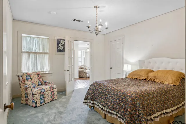 a bedroom with a large bed and a large window