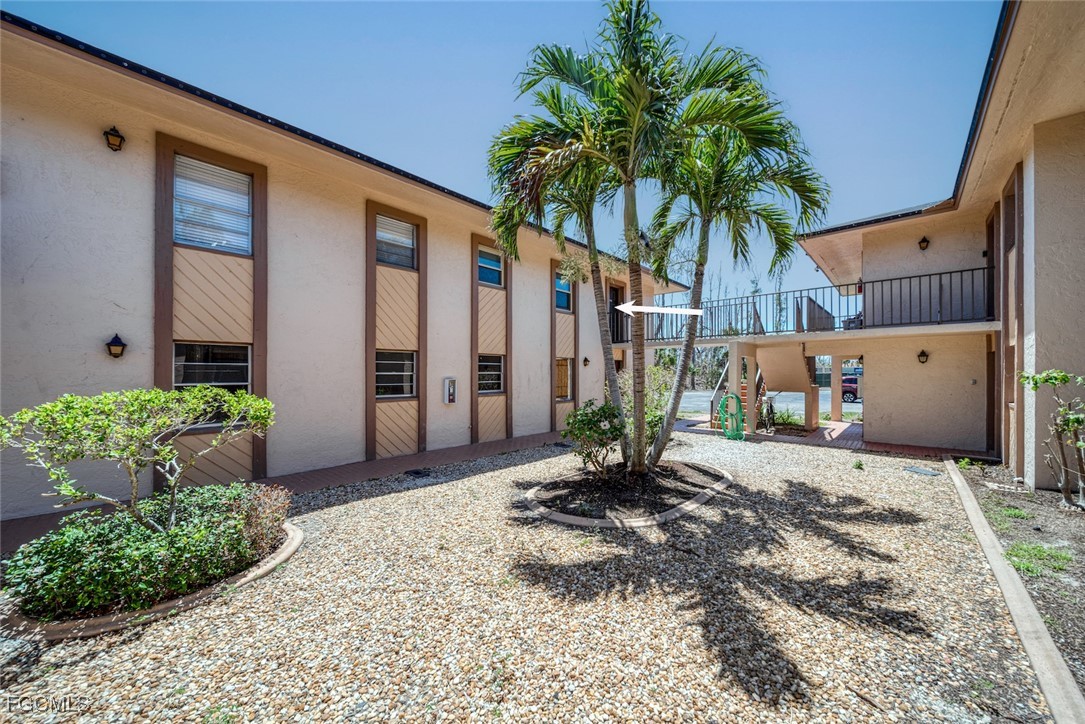 16881 Davis Road, Unit 721 Fort Myers, FL 33908 - Photo 21 of 23 a couple of potted plants in front of door