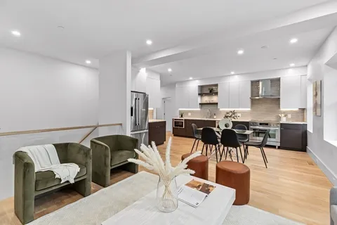 a living room with furniture and kitchen view