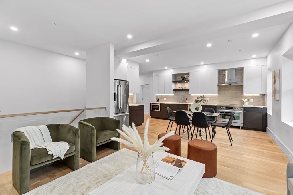 a living room with furniture and kitchen view