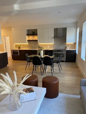 a living room with furniture a rug and a flat screen tv