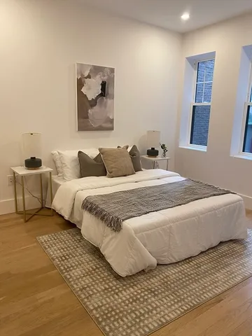 a bedroom with a large bed and a couch