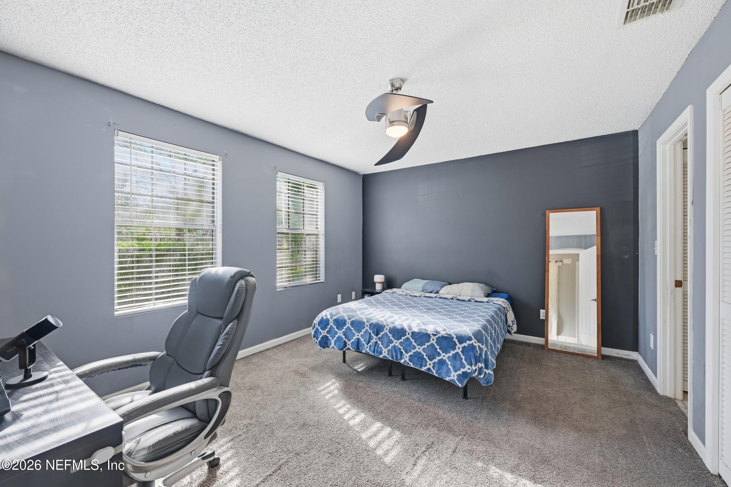 12890 Attrill Road Jacksonville, FL 32258 - Photo 11 of 29 a bedroom with a bed and glass window