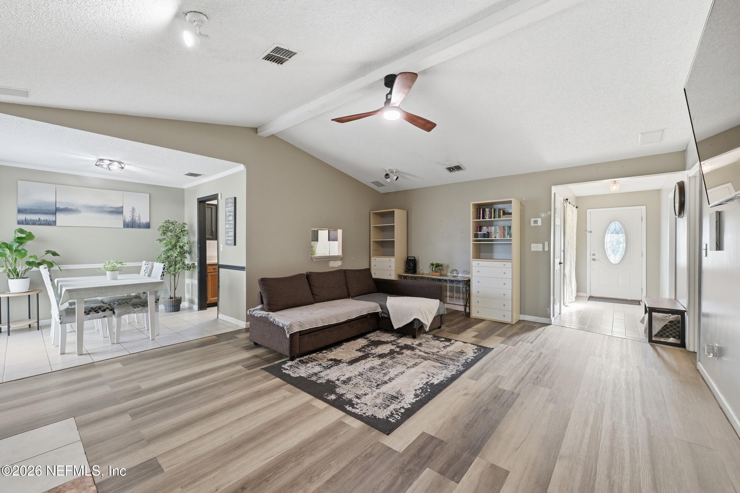 12890 Attrill Road Jacksonville, FL 32258 - Photo 7 of 29 a living room with furniture and wooden floor