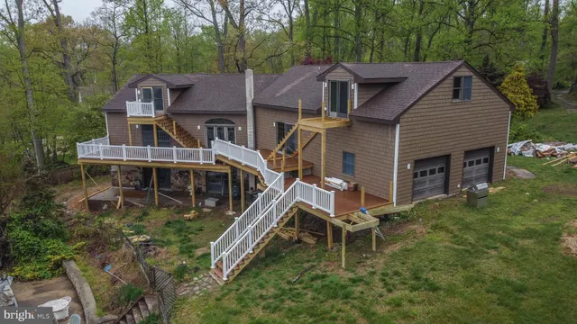 a kitchen with stainless steel appliances granite countertop a stove a sink dishwasher and cabinets with wooden floor