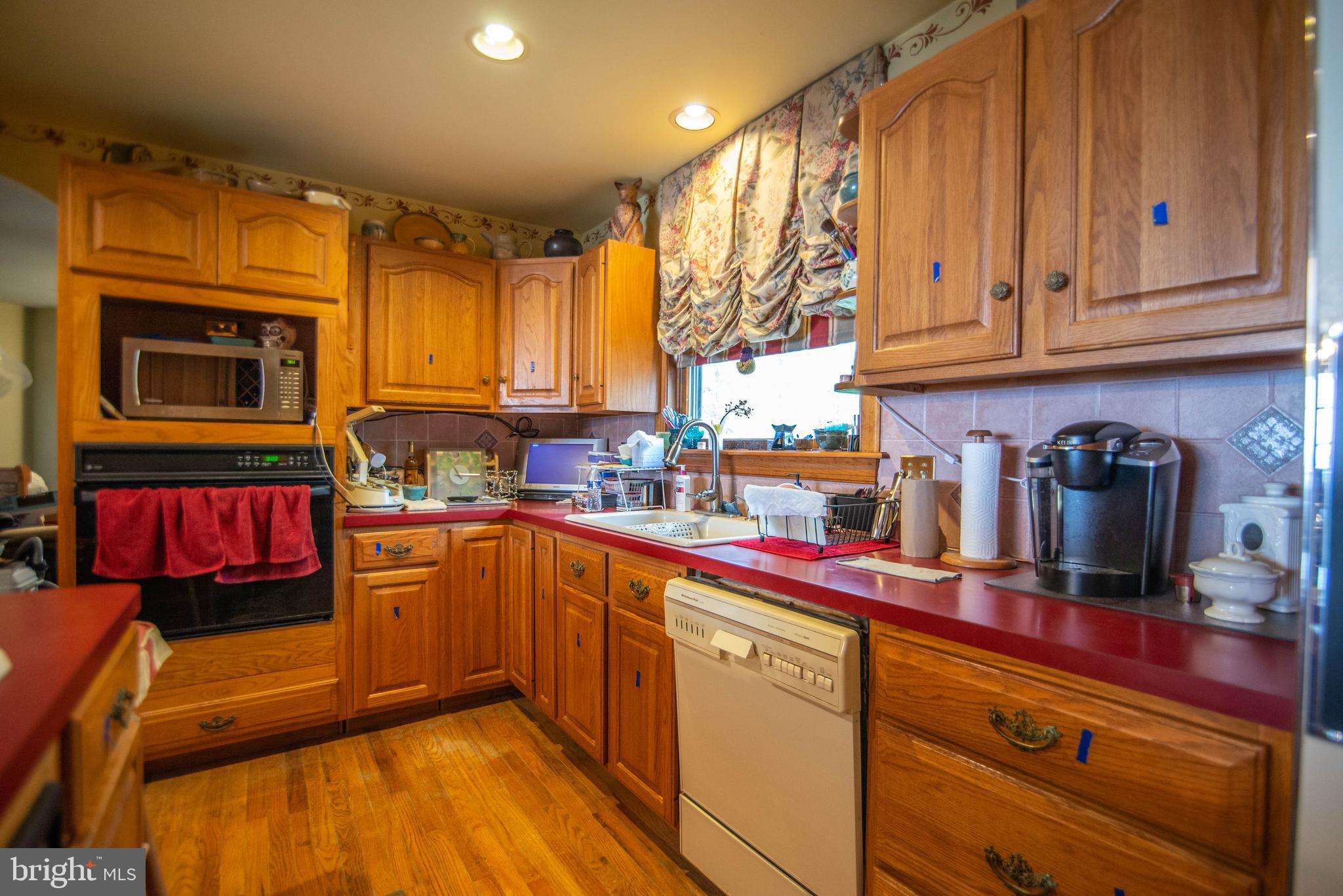 38 Osprey Way Elkton, MD 21921 - Photo 15 of 52 a kitchen with stainless steel appliances granite countertop a stove a sink dishwasher and cabinets with wooden floor