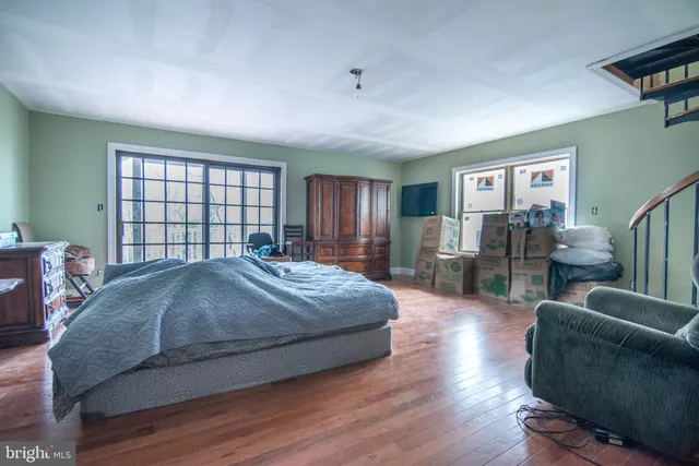 a living room with furniture a air conditioner and a table