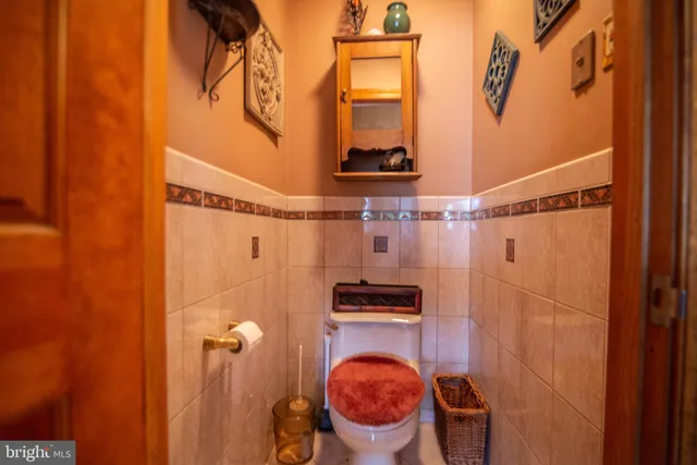 a bathroom with a sink toilet and a mirror