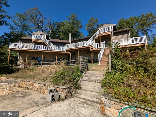 a view of a wooden deck with chairs