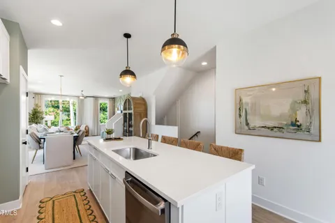 a view of a dining room with furniture a chandelier and wooden floor