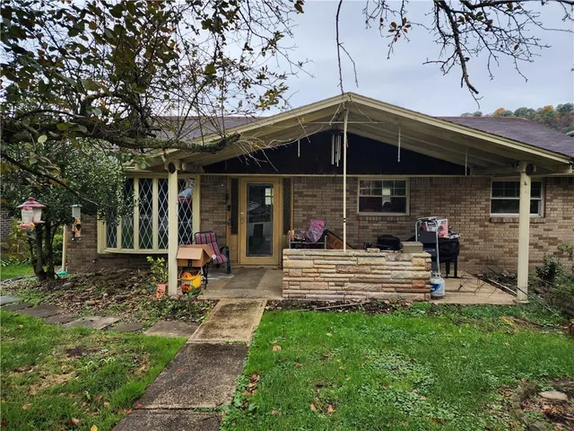 a view of a house with backyard porch and sitting area
