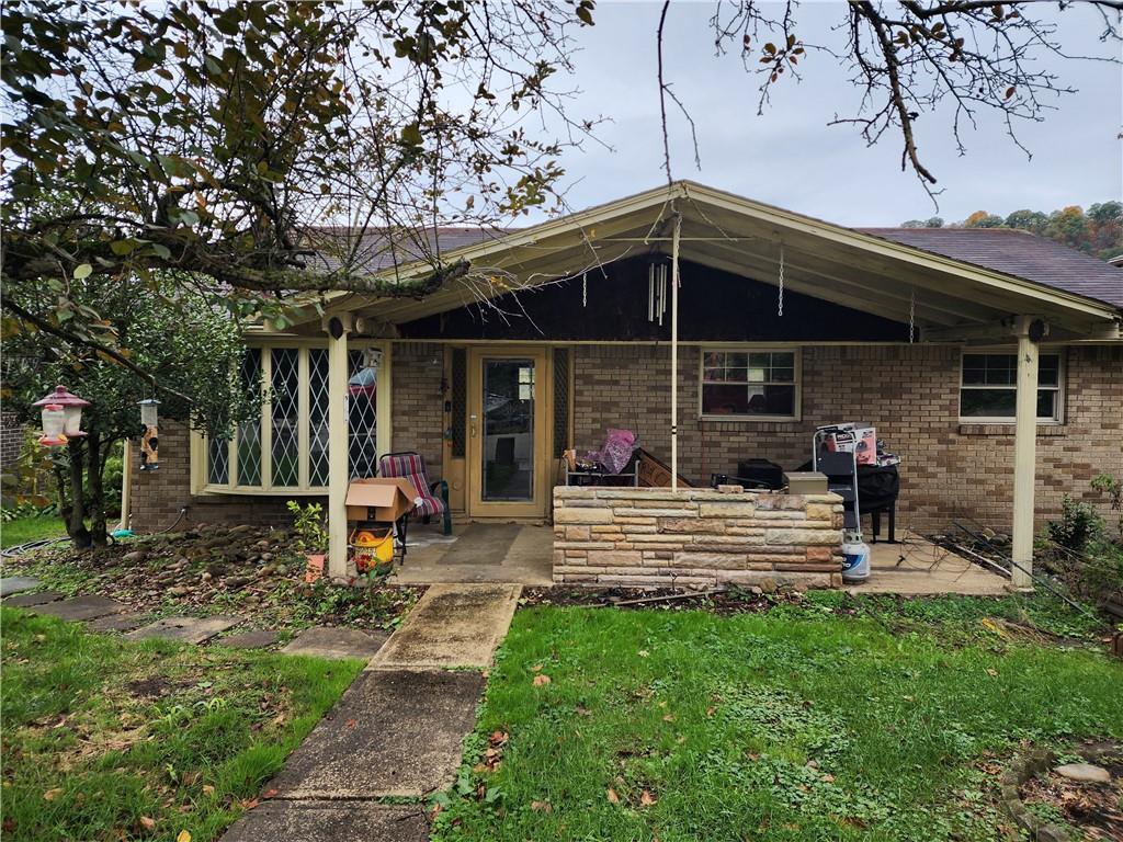a view of a house with backyard porch and sitting area