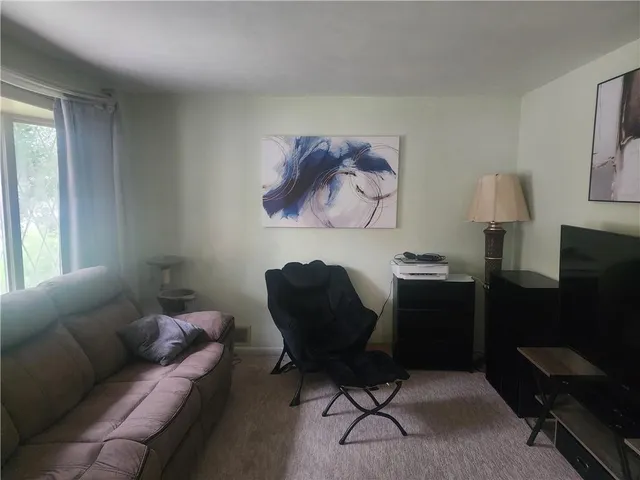 a living room with furniture and a lamp