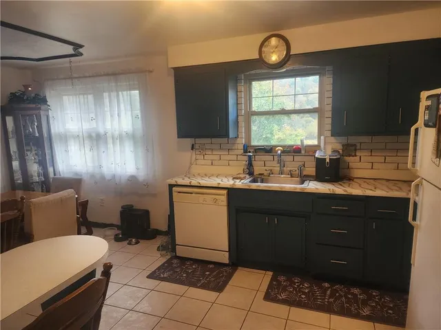 a kitchen with a sink window and cabinets